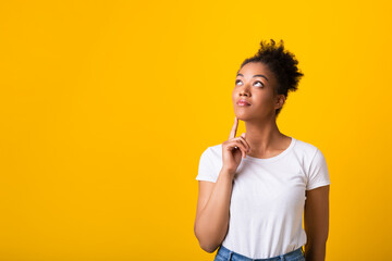 Portrait of black lady looking up at studio