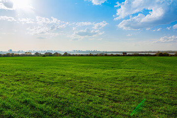 Green grass field and bright blue sky. Beautiful summer landscape near Burgas, Bulgaria