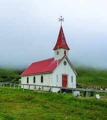 Fototapeta na wymiar Small little red church in the fog, Vik, Iceland
