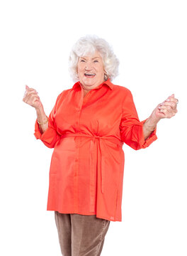 A senior elderly woman in a red blouse isolated on a white background.