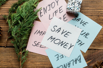 Motivational text, phrases on note papers with fir, spruce branches on wooden background