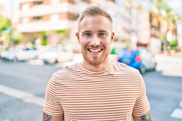 Young irish man smiling happy walking at street of city.