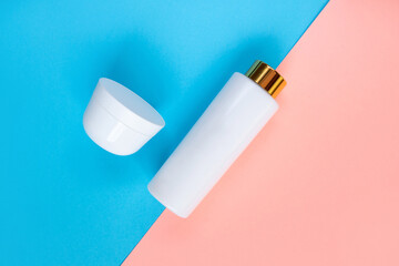 Cosmetic Bottle Set for liquid, cream, gel, lotion. Сosmetic bottle Set on blue and rose background. SPA cosmetic products branding mockup.
Flat lay minimalist style.