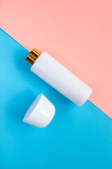 Cosmetic Bottle Set for liquid, cream, gel, lotion. Сosmetic bottle Set on blue and rose background. SPA cosmetic products branding mockup.
Flat lay minimalist style.