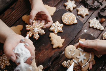 Family decorating Christmas gingerbread cookies