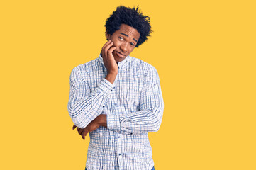 Handsome african american man with afro hair wearing casual clothes thinking looking tired and bored with depression problems with crossed arms.