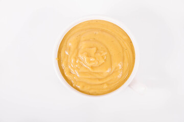 Pumpkin soup in a bowl on a white background