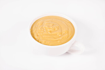 Pumpkin soup in a bowl on a white background