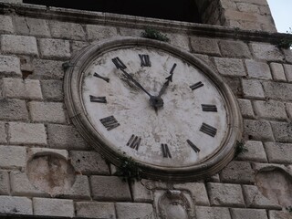 Antique clock on a brick wall