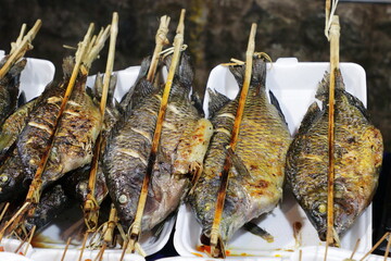 Grilled fish sold in an Asian food street market