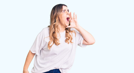Fototapeta premium Young caucasian woman wearing casual clothes shouting and screaming loud to side with hand on mouth. communication concept.
