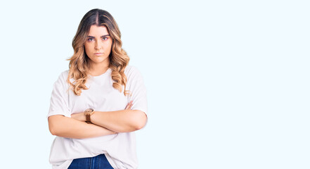 Young caucasian woman wearing casual clothes skeptic and nervous, disapproving expression on face with crossed arms. negative person.