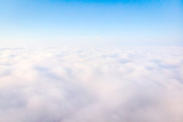 Aerial view to white silky clouds with light blue empty sky in the background.Heaven blank space...