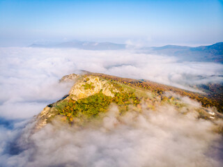 Aerial birds view to Kojori fortress on the hill in autumn surounded by the clouds