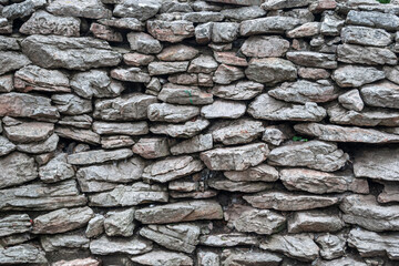 
stone wall. rustic stone wall background.