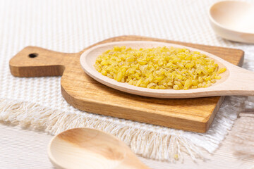 raw grain Bulgur porridge. Healthy, dietary, vegan, gluten free product. Organic product made from wheat grains. Close-up.