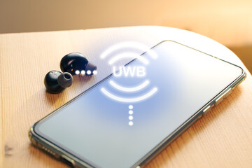 UWB or ultra wireband radio technology Wireless earphones connecting to a smartphone