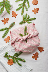 Fototapeta na wymiar Christmas eco-friendly gift wrap in traditional japanese furoshiki style, eco-friendly gift wrap and Zero Wast concept