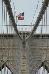 Brooklyn Bridge pilar with flag and kabels