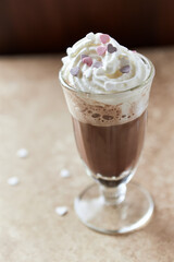 Coffee with whipped cream on bright stone background. Soft focus. Close up.