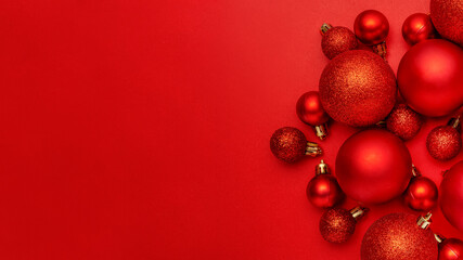 Nice composition of red christmas balls on red background