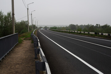 View of the center of the road with fog on the background