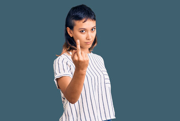 Young woman wearing casual clothes showing middle finger, impolite and rude fuck off expression