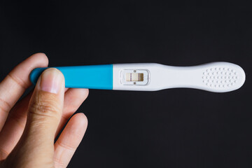 
Woman's hand holding a positive pregnancy test
