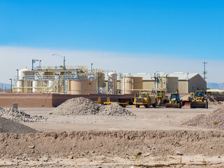 Sunny view of some Heavy equipment and a factory