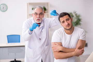 Young man visiting experienced doctor dermatologist