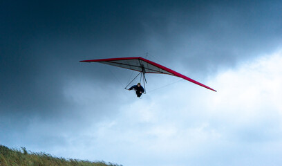 Naklejka na ściany i meble hang glider pilot approaches the photographer