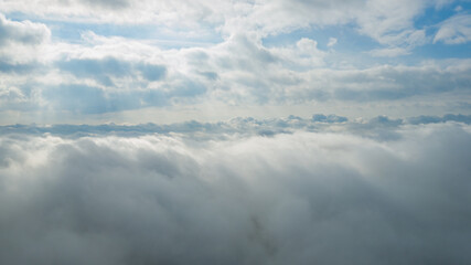 Panoramic view of beautiful blue sky with clouds and sun lights. View above clouds.