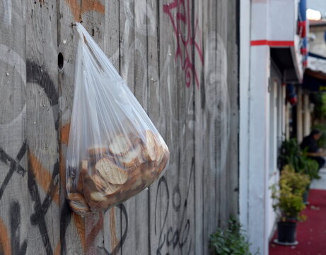 A bag of old bread for the poor hangs on a fence on Abdul Ezel Pasha street in Istanbul. Turkey