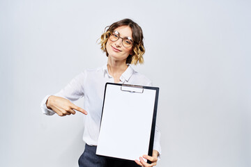 Naklejka premium Business woman with a folder of white documents in her hand on a light background And hairstyle glasses model