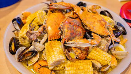 Close up shot of fresh steamed crab, corn, mussel, shrimp