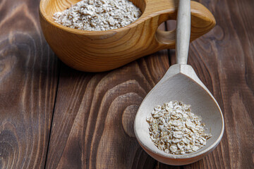 Wooden Cup and spoon with oatmeal. Health food. Wood texture