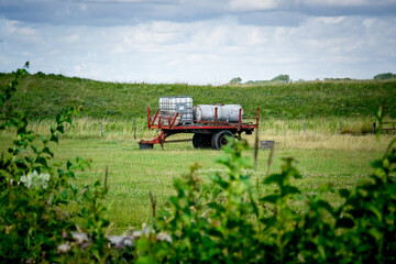 Fototapeta premium Tractor trailor in grass field