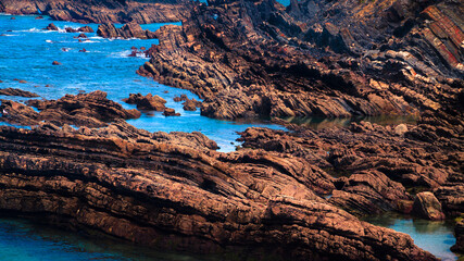 Fototapeta na wymiar rocky coast of the sea with rocks surrounded by water