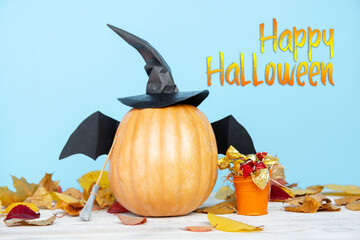 fresh halloween pumpkin, gourd, squash witch hat and bat wings candy bowl of chocolates and sweets,...