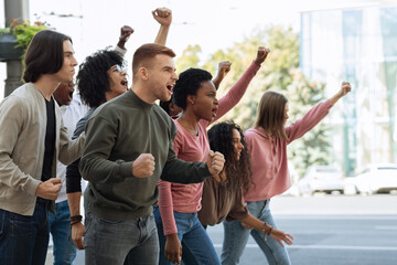 Group of students chanting slogans and showing fists during demonstration
