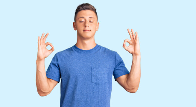 Young handsome hispanic man wearing casual clothes relax and smiling with eyes closed doing meditation gesture with fingers. yoga concept.