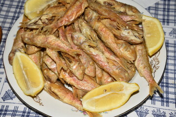 Fried Anchovies in the Plate With lemons