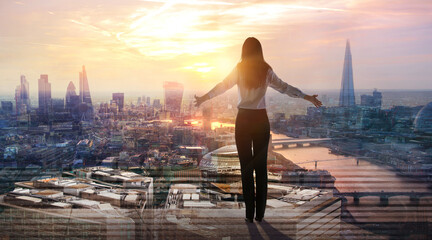 Fototapeta premium Young woman looking at city of London at sunset. River Thames, embankment, business area of the City. London, UK
