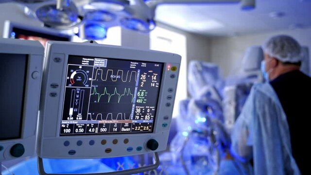 Anasthesia monitor on blur surgery background. Medical monitor shows vital signs of a patient during the operating process in intensive care unit.