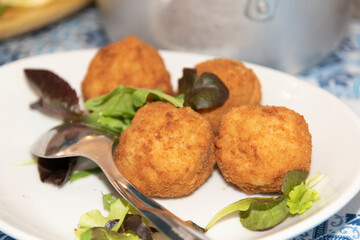 Fried Breaded Balls in the Plate With Salad Leafs