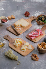 Fototapeta na wymiar Wooden boards full of delisious appetizers cheese, salumi, grapes, honey and nuts