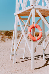 white rescue post with a lifebuoy. on a Sunny summer day. Coastal architecture. Wooden rescue post...
