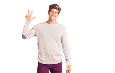 Young handsome man wearing casual clothes showing and pointing up with fingers number three while smiling confident and happy.