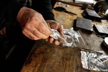 Hand-made silver items with cloisonné enamel in progress. Traditional work in the mountain village of Kubachi, Dagestan.