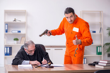 Old male judge meeting with young captive in courthouse